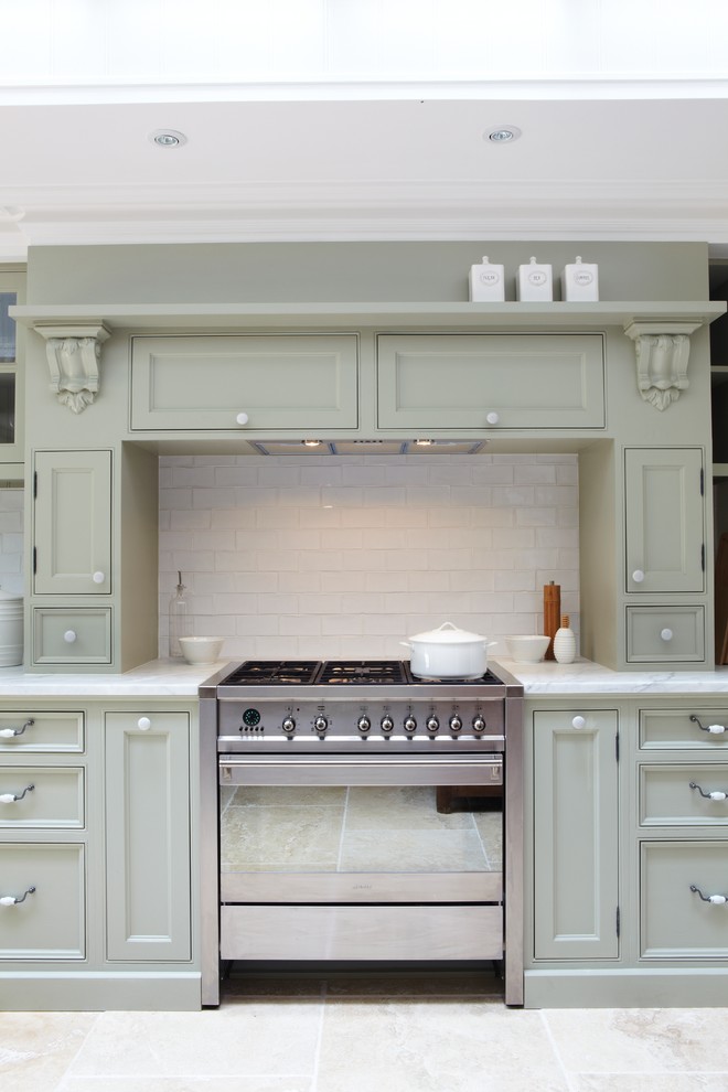 Large traditional u-shaped eat-in kitchen in Sydney with a farmhouse sink, shaker cabinets, green cabinets, marble benchtops, white splashback, ceramic splashback, stainless steel appliances, travertine floors and no island.