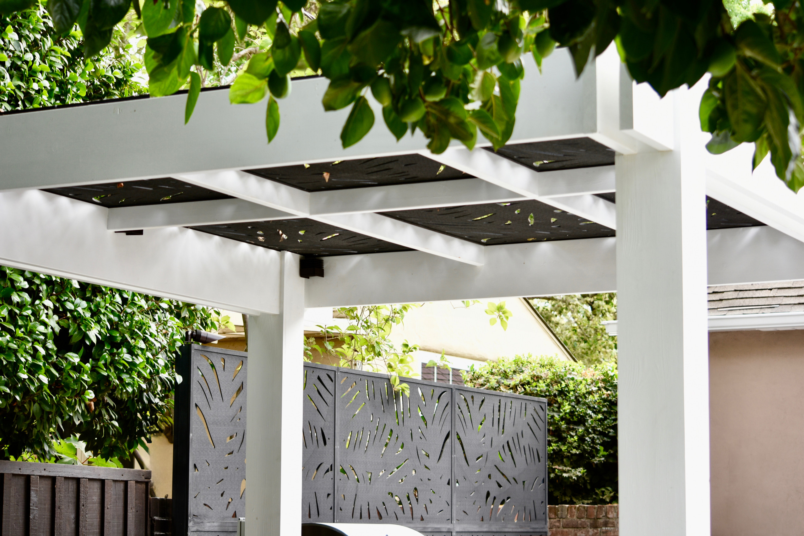 Cut-Out Trellises Top the Pergola & Give Privacy at Outdoor Kitchen