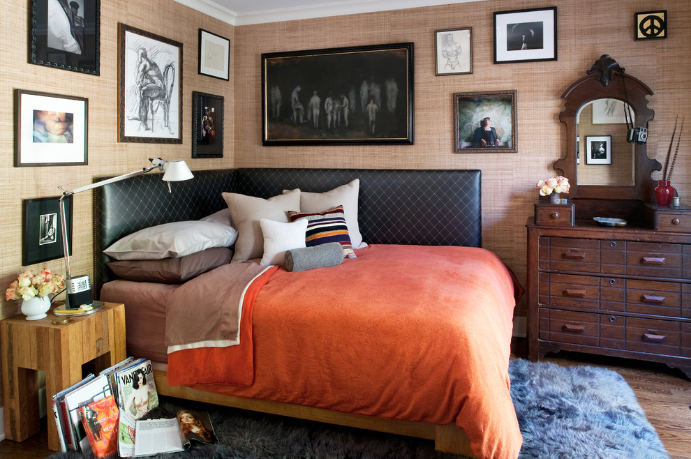 Photo of an eclectic bedroom in Los Angeles with beige walls and medium hardwood floors.