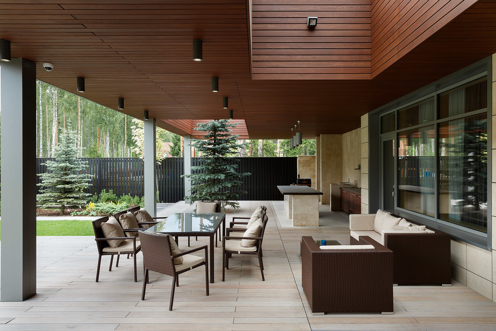 Contemporary patio in Moscow with a roof extension.