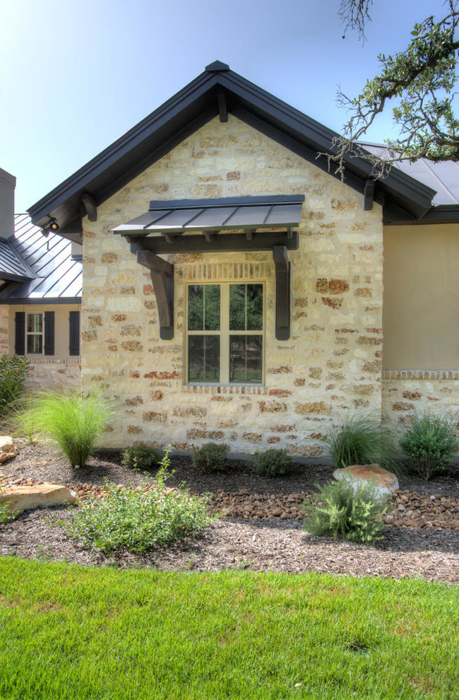 Design ideas for a country exterior in Austin with stone veneer.