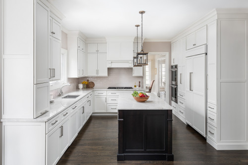 Bright transitional kitchen with white shaker cabinets, a black island base, quartz countertop, and built-in stainless appliances—Kitchen Cabinet Mississauga.