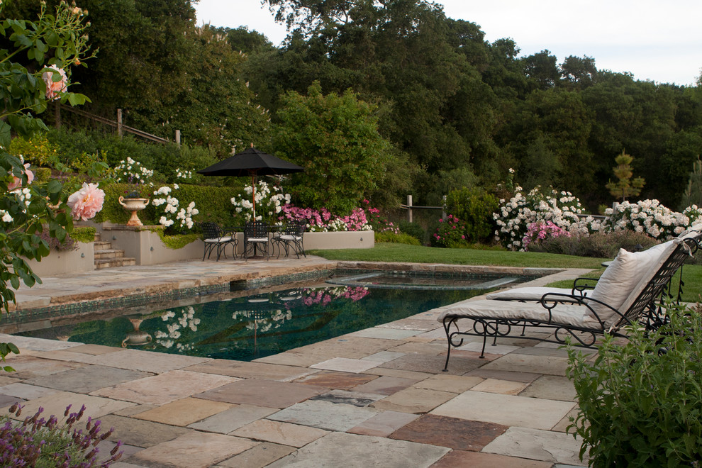 This is an example of a small mediterranean rectangular pool in San Francisco with natural stone pavers.