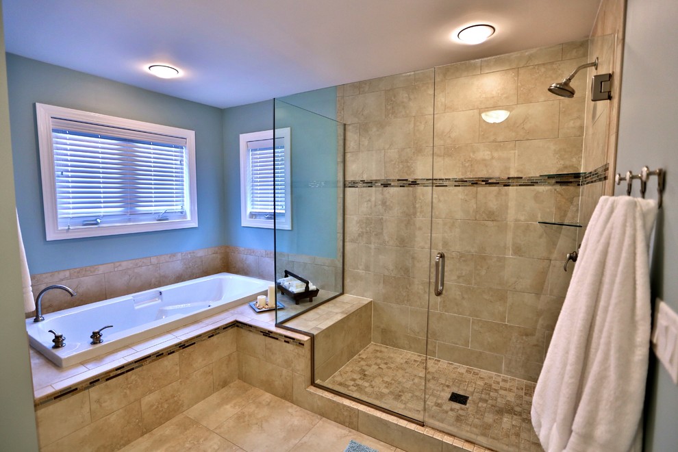 This is an example of a large traditional master bathroom in Chicago with an undermount sink, flat-panel cabinets, dark wood cabinets, solid surface benchtops, a drop-in tub, a two-piece toilet, beige tile, stone tile, an alcove shower, green walls and porcelain floors.