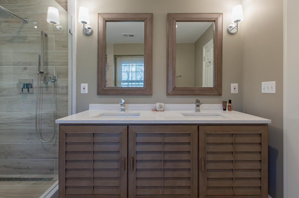 Inspiration for a mid-sized contemporary master bathroom in DC Metro with furniture-like cabinets, light wood cabinets, a one-piece toilet, beige tile, porcelain tile, beige walls, porcelain floors, an undermount sink, engineered quartz benchtops, beige floor, white benchtops, a double vanity and a freestanding vanity.