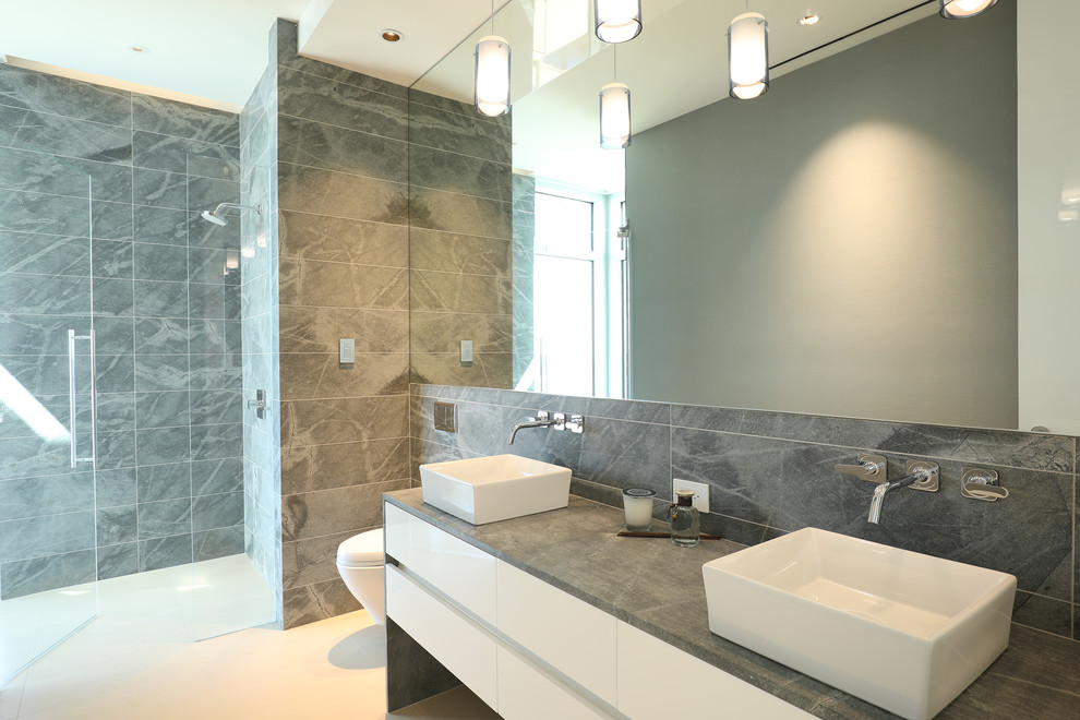 Design ideas for a contemporary master wet room bathroom with white cabinets, a corner tub, white tile, marble, brown walls, marble floors, a drop-in sink, marble benchtops, white floor and a hinged shower door.