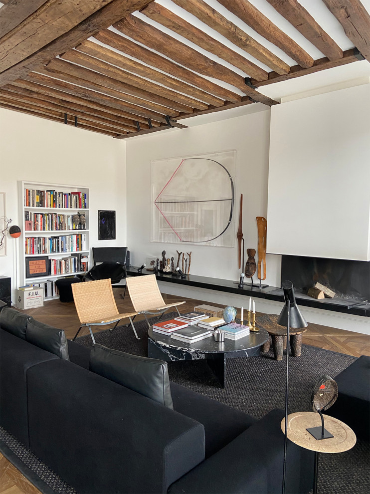 Inspiration for a large contemporary open concept living room in Paris with a library, white walls, medium hardwood floors, no tv, brown floor, a ribbon fireplace and exposed beam.