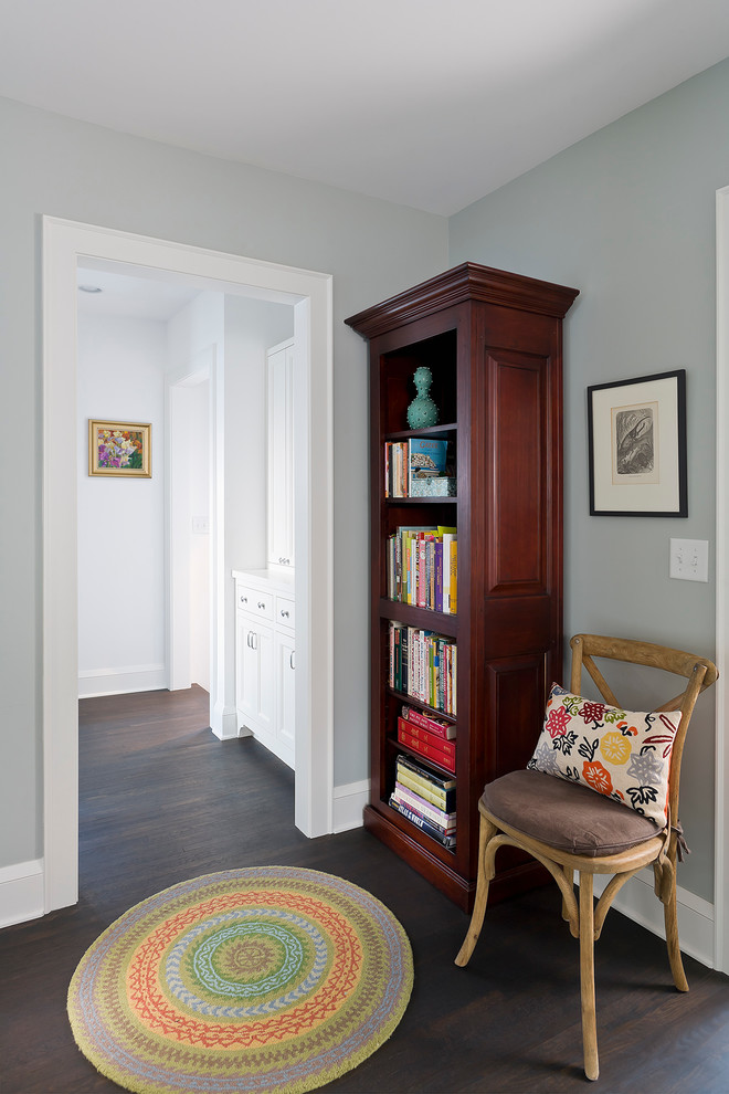Photo of a small traditional hallway in Minneapolis with blue walls, dark hardwood floors and brown floor.