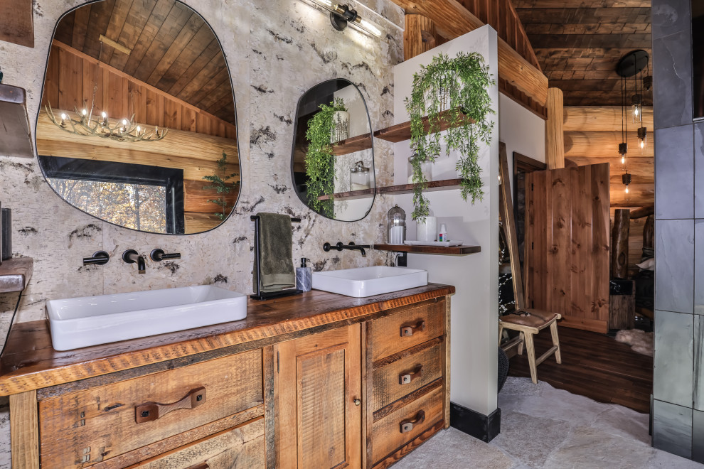 Inspiration for a mid-sized rustic master slate floor, gray floor, double-sink, exposed beam and wood wall bathroom remodel with furniture-like cabinets, medium tone wood cabinets, white walls, wood countertops, brown countertops and a freestanding vanity