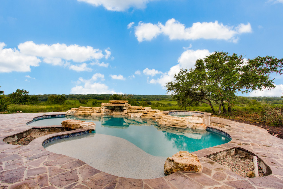 Hot tub - large transitional backyard stone and kidney-shaped natural hot tub idea in Austin