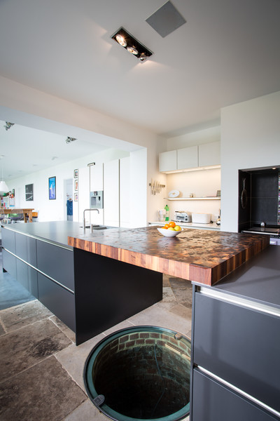 Photo of a large contemporary galley eat-in kitchen in Hampshire with an undermount sink, flat-panel cabinets, grey cabinets, quartz benchtops, stainless steel appliances, travertine floors and with island.