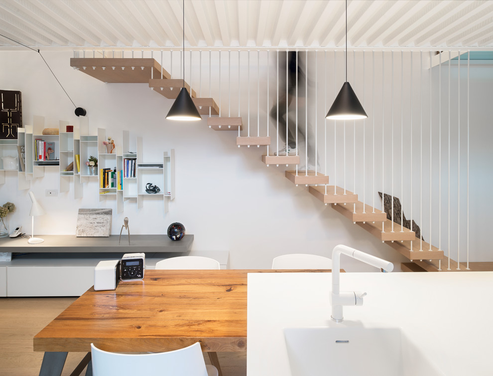 Scandinavian wood floating staircase in Milan with open risers.