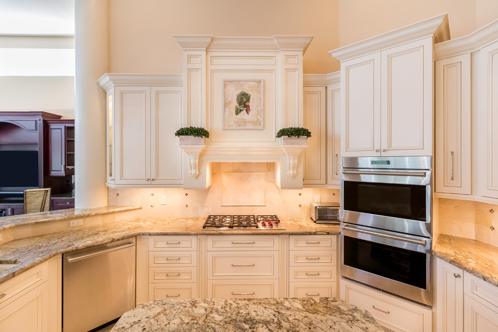 Example of a large transitional u-shaped marble floor kitchen design in Miami with a single-bowl sink, shaker cabinets, white cabinets, granite countertops, beige backsplash, ceramic backsplash, stainless steel appliances and an island
