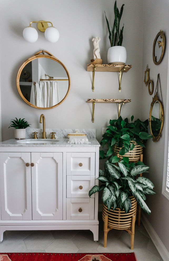Inspiration for a small bohemian family bathroom in Atlanta with freestanding cabinets, white cabinets, an alcove bath, a shower/bath combination, a one-piece toilet, white tiles, ceramic tiles, porcelain flooring, a submerged sink, marble worktops, grey floors, a shower curtain, white worktops, a single sink and a freestanding vanity unit.