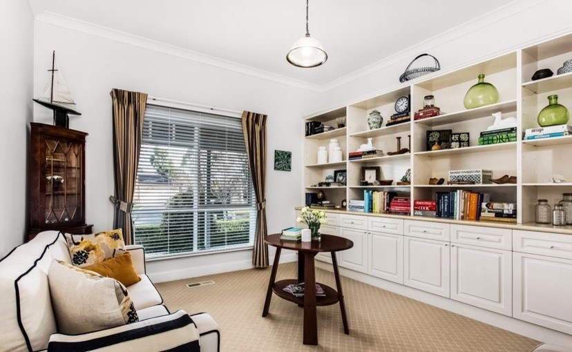 Photo of a mid-sized eclectic study room in Melbourne with white walls, carpet and beige floor.