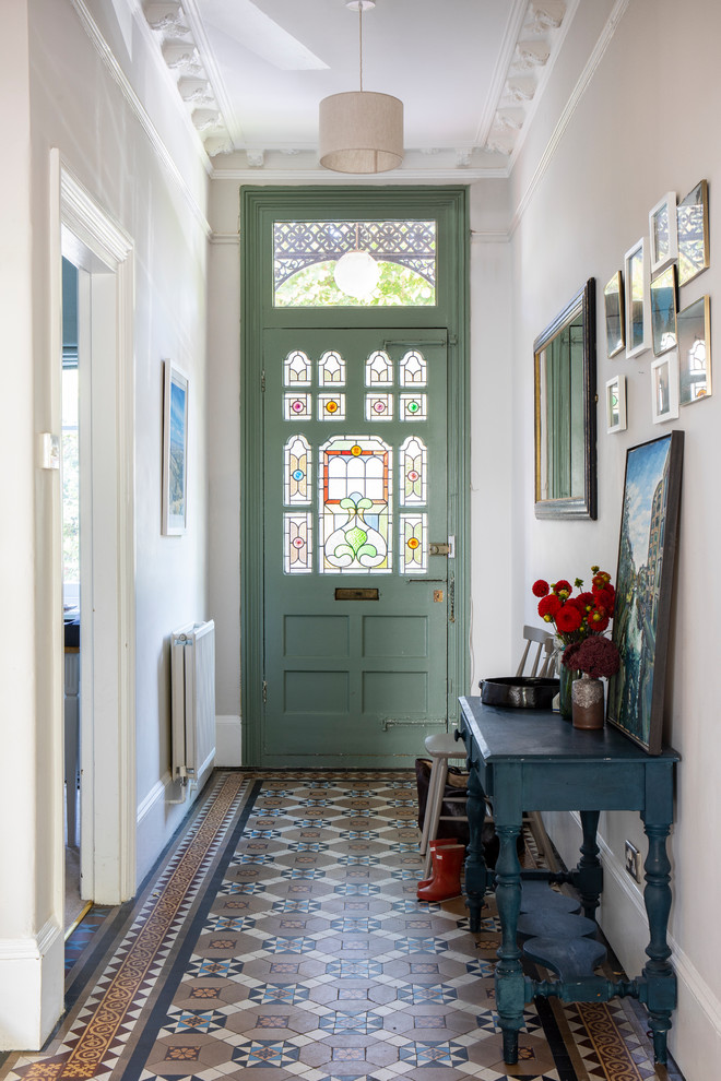 Design ideas for a mid-sized traditional front door in London with white walls, ceramic floors, a single front door, a green front door and multi-coloured floor.