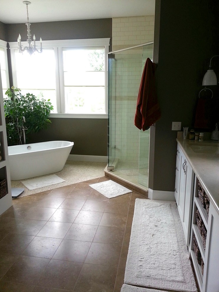 Design ideas for a large country master bathroom in Denver with an undermount sink, shaker cabinets, white cabinets, marble benchtops, a freestanding tub, a corner shower, a two-piece toilet, brown tile, stone tile, brown walls and travertine floors.