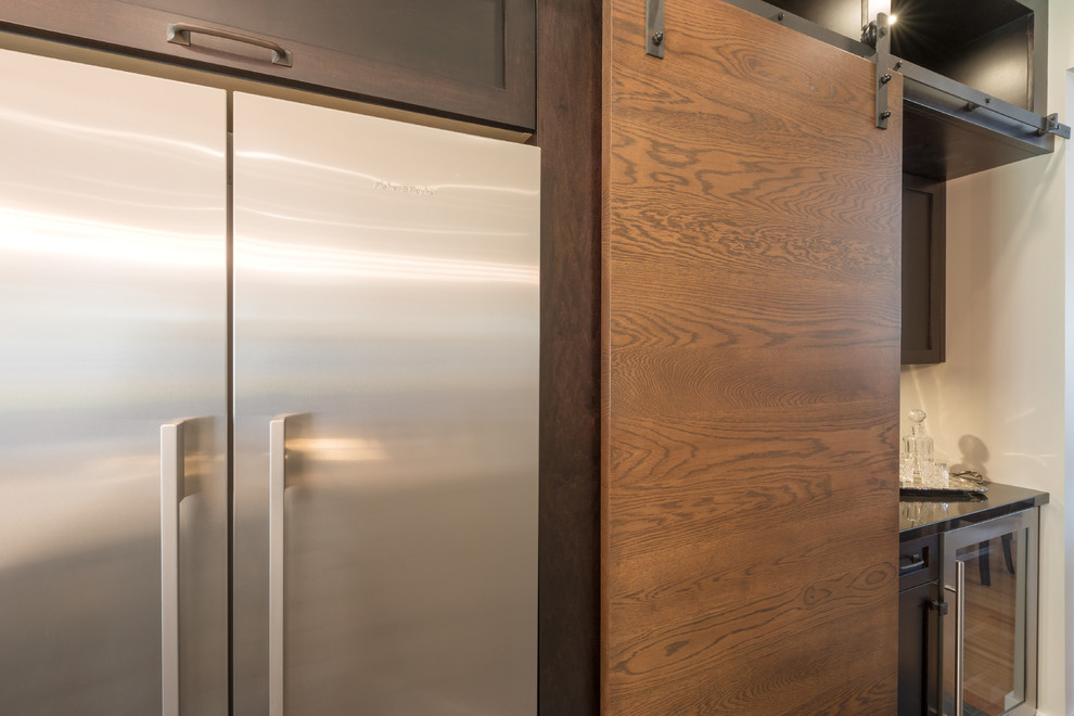 Example of a large transitional slate floor and multicolored floor kitchen pantry design in Vancouver with an undermount sink, shaker cabinets, dark wood cabinets, quartz countertops, white backsplash, porcelain backsplash, stainless steel appliances, an island and white countertops