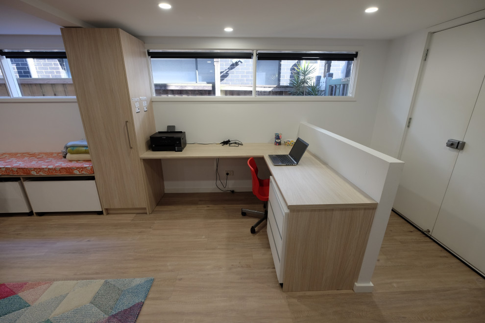 Photo of a large contemporary kids' playroom for kids 4-10 years old in Sydney with white walls and vinyl floors.