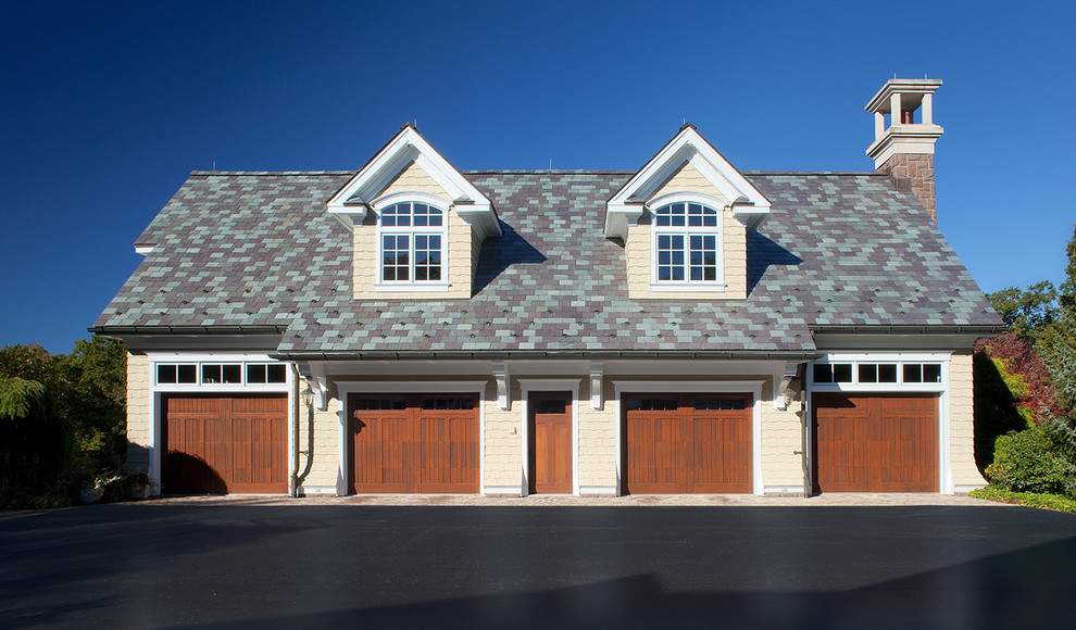 Photo of an expansive traditional detached four-car garage in Grand Rapids.