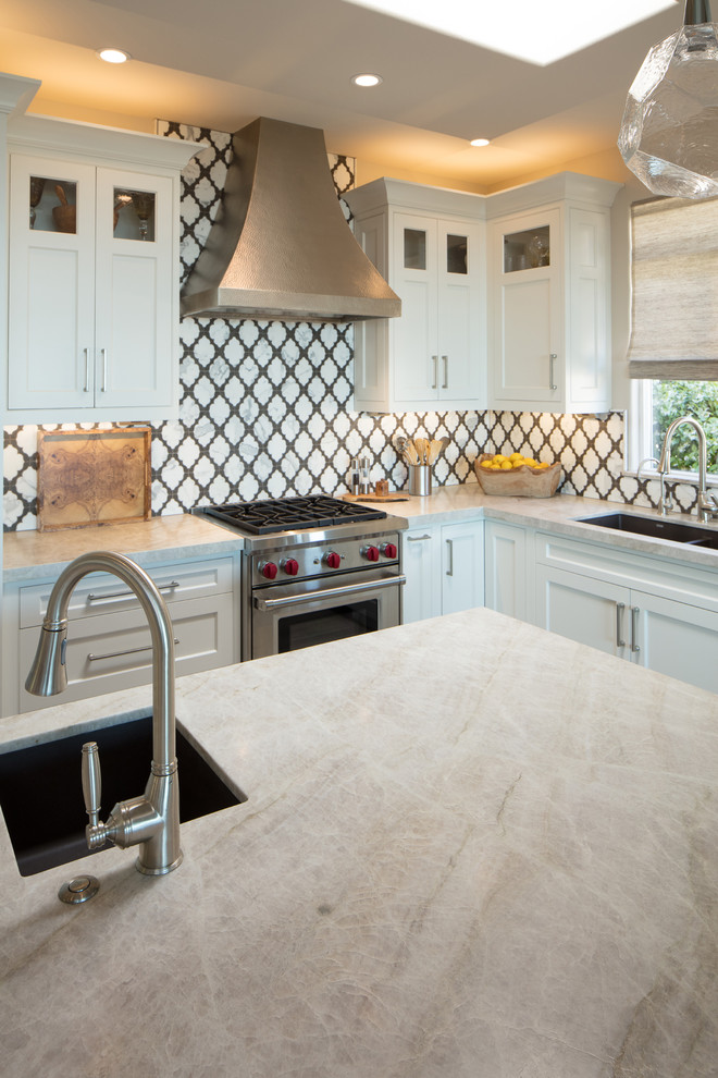 Inspiration for a mid-sized transitional l-shaped open plan kitchen in San Luis Obispo with an undermount sink, shaker cabinets, white cabinets, multi-coloured splashback, ceramic splashback, panelled appliances, porcelain floors, with island, grey floor and beige benchtop.