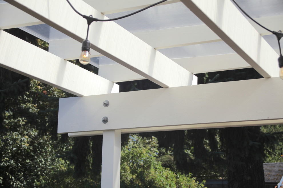 Mid-sized arts and crafts backyard deck photo in Seattle with a pergola