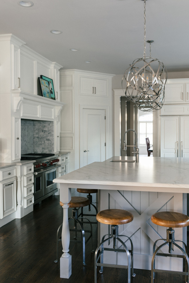 Inspiration for a large transitional u-shaped medium tone wood floor and brown floor eat-in kitchen remodel in Atlanta with an undermount sink, raised-panel cabinets, white cabinets, marble countertops, white backsplash, marble backsplash, stainless steel appliances and an island