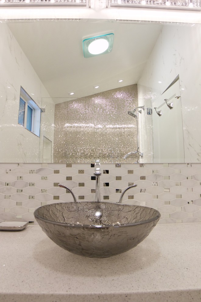 Alcove shower - mid-sized transitional 3/4 gray tile, white tile and mosaic tile marble floor and white floor alcove shower idea in Orange County with beaded inset cabinets, white cabinets, white walls, a vessel sink, quartz countertops and a hinged shower door
