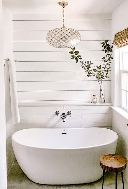 Mid-sized trendy master white tile and ceramic tile ceramic floor and beige floor freestanding bathtub photo in Charlotte with a two-piece toilet, white walls, an undermount sink, engineered quartz countertops, a hinged shower door and white countertops