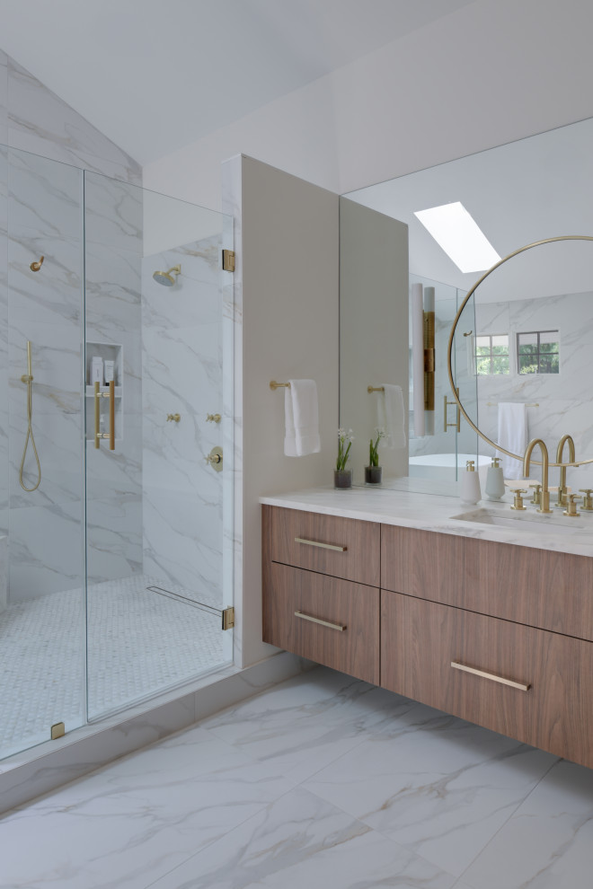 Design ideas for an expansive modern master bathroom in DC Metro with flat-panel cabinets, medium wood cabinets, a freestanding tub, a corner shower, a bidet, white tile, porcelain tile, white walls, porcelain floors, an undermount sink, marble benchtops, white floor, a hinged shower door, white benchtops, a shower seat, a double vanity, a floating vanity, vaulted and panelled walls.