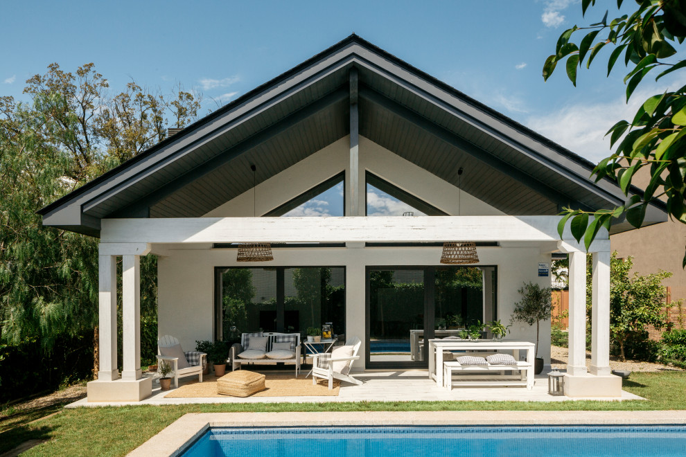 Modelo de terraza escandinava de tamaño medio en patio trasero y anexo de casas con suelo de baldosas