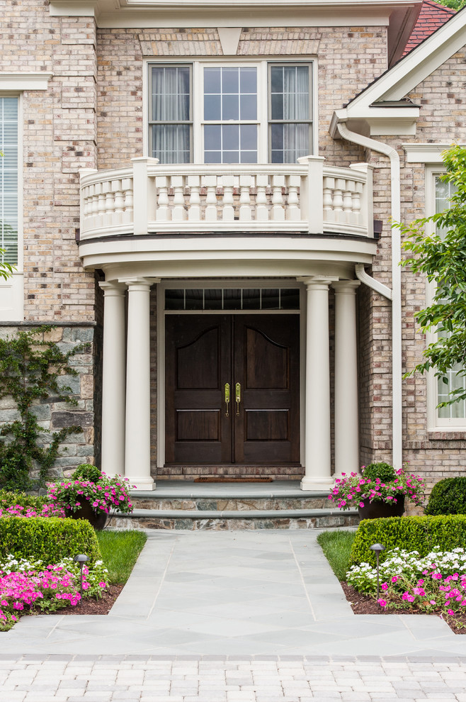 Inspiration for a traditional front door in DC Metro with a double front door and a dark wood front door.