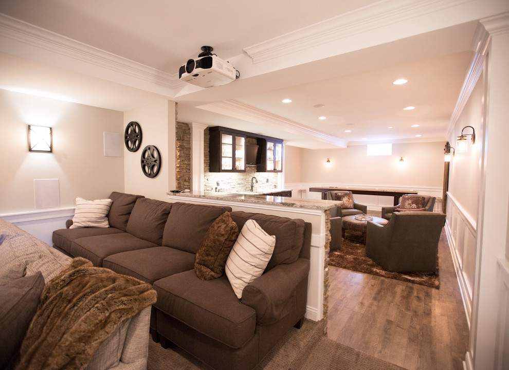 Inspiration for a large transitional open concept family room in Chicago with a game room, beige walls, medium hardwood floors, no fireplace, a built-in media wall and brown floor.