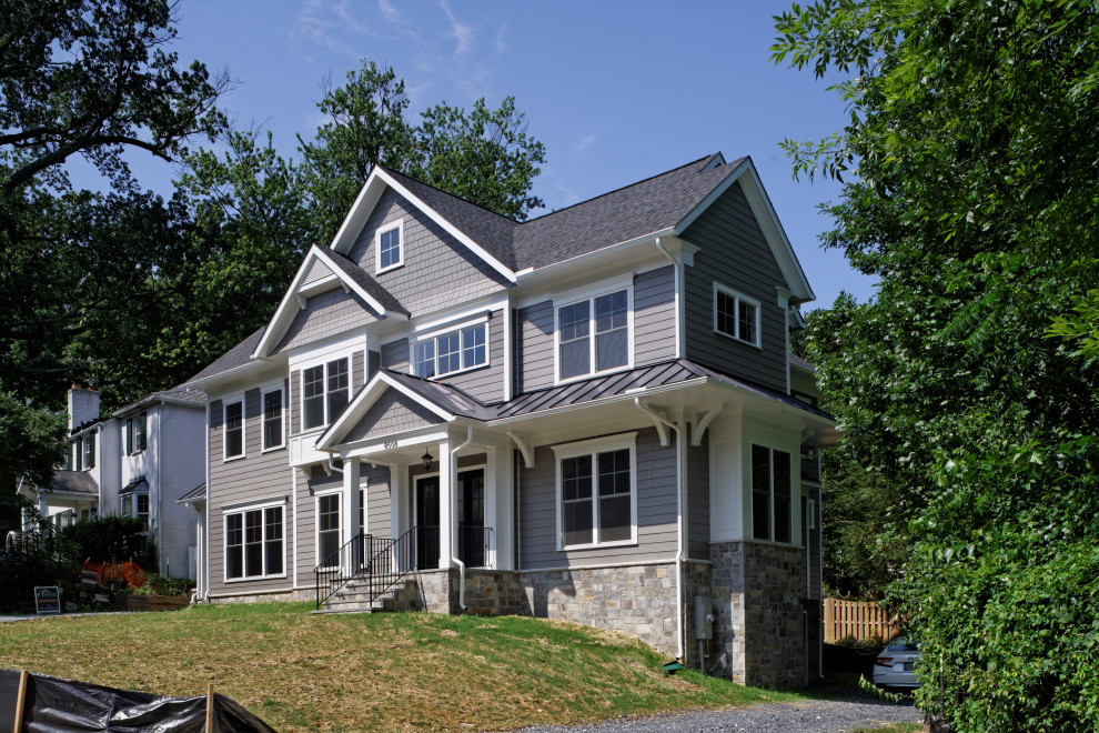 Inspiration for a large transitional grey house exterior in DC Metro with a gable roof, a mixed roof, a black roof, clapboard siding, four or more storeys and concrete fiberboard siding.
