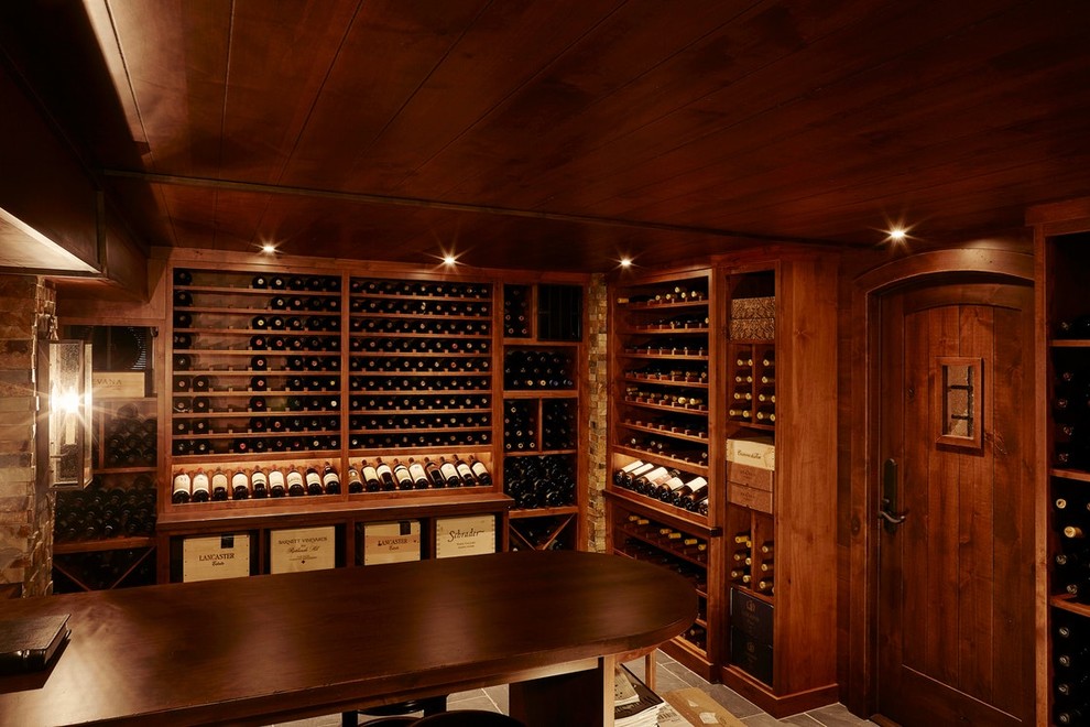 Photo of a large traditional wine cellar in Minneapolis with slate floors, display racks and grey floor.