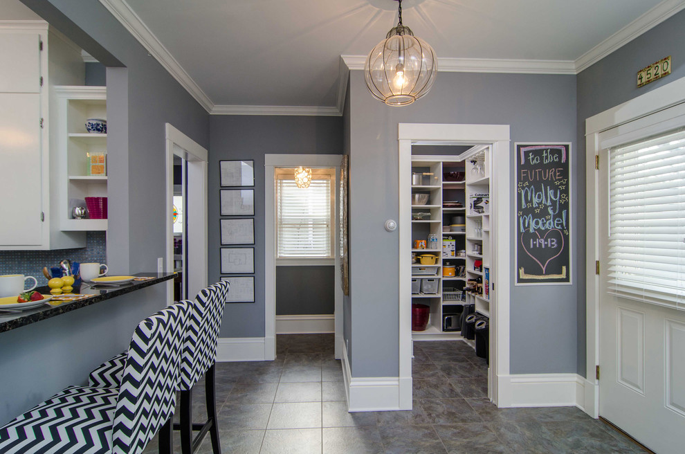 Photo of a mid-sized traditional foyer in Minneapolis with grey walls, a single front door, a white front door, slate floors and grey floor.