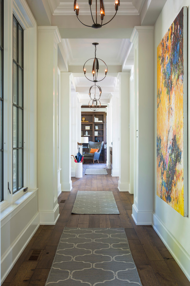 Design ideas for a traditional hallway in Minneapolis with white walls and dark hardwood floors.