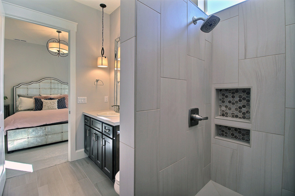 Large transitional 3/4 gray tile and ceramic tile porcelain tile and gray floor walk-in shower photo in Portland with recessed-panel cabinets, dark wood cabinets, a two-piece toilet, beige walls, an undermount sink and tile countertops