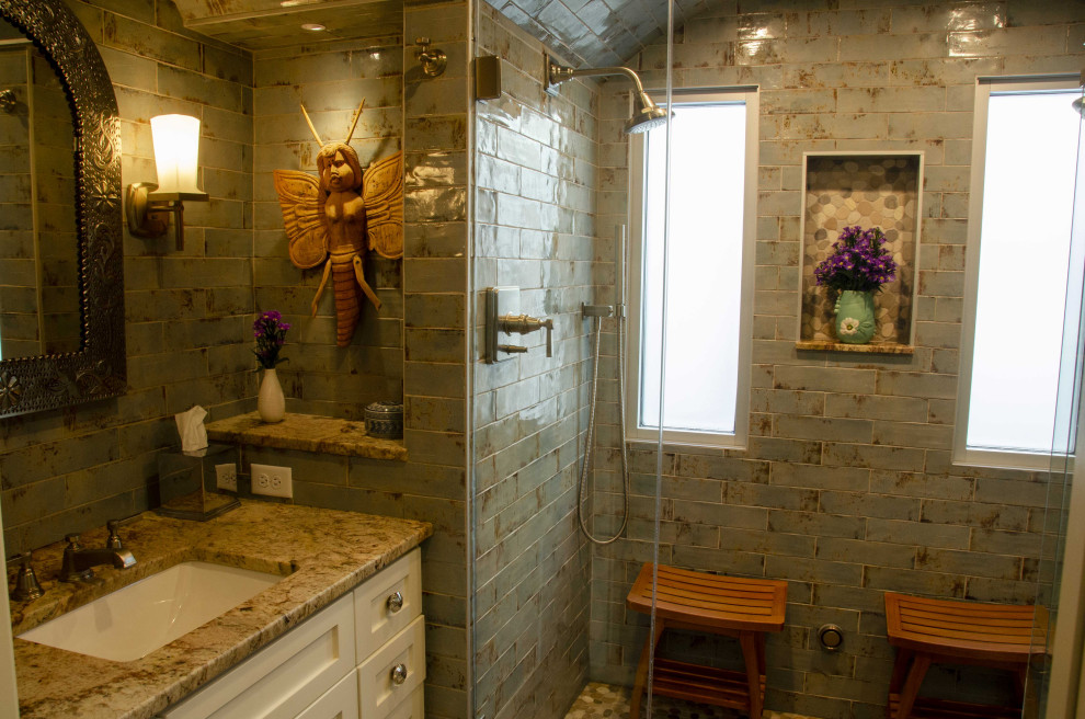 This is an example of a mid-sized arts and crafts master bathroom in Minneapolis with flat-panel cabinets, white cabinets, an open shower, a one-piece toilet, green tile, ceramic tile, green walls, ceramic floors, an undermount sink, granite benchtops, green floor, a hinged shower door, green benchtops, a single vanity and a built-in vanity.