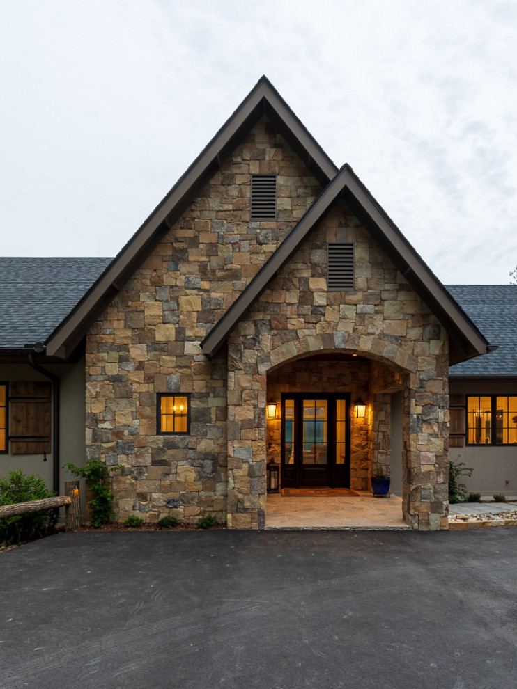 Example of a transitional medium tone wood floor and brown floor foyer design with a dark wood front door