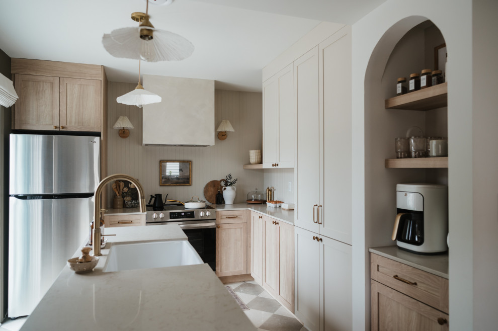 Kitchen - small transitional l-shaped ceramic tile and multicolored floor kitchen idea in Toronto with a farmhouse sink, shaker cabinets, quartzite countertops, beige backsplash, shiplap backsplash, stainless steel appliances, an island, beige countertops and light wood cabinets