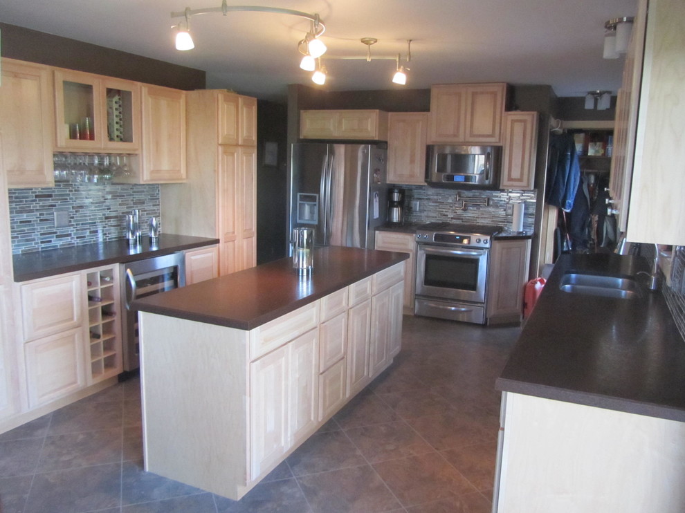Enclosed kitchen - mid-sized transitional galley porcelain tile and beige floor enclosed kitchen idea with a double-bowl sink, raised-panel cabinets, light wood cabinets, granite countertops, beige backsplash, porcelain backsplash, stainless steel appliances and an island