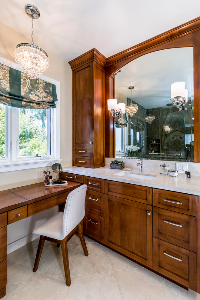 This is an example of a mid-sized transitional master bathroom in San Francisco with an undermount sink, recessed-panel cabinets, medium wood cabinets, quartzite benchtops, a corner shower and travertine floors.