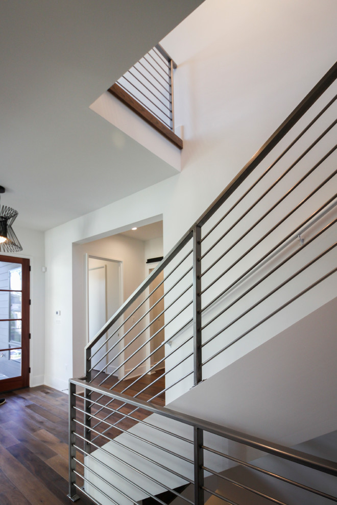 Design ideas for a large contemporary wood floating staircase in DC Metro with metal railing.