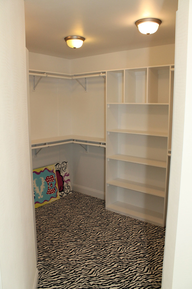 Example of a large classic women's carpeted walk-in closet design in Other with open cabinets