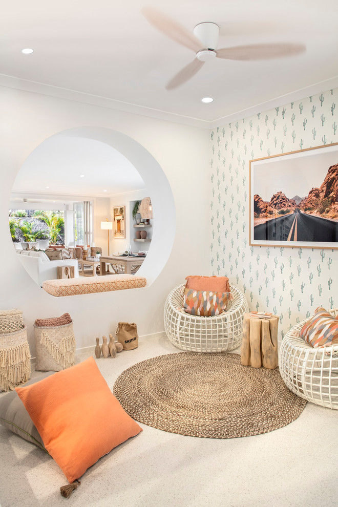 This is an example of a beach style family room in Brisbane with white walls and beige floor.