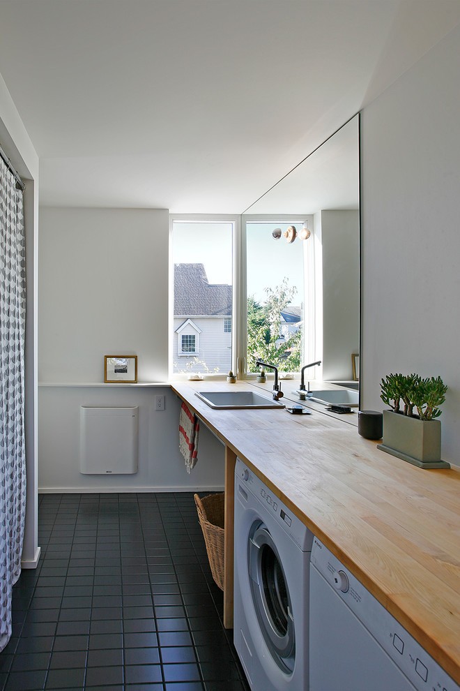 Country single-wall utility room in Seattle with a drop-in sink, wood benchtops and a side-by-side washer and dryer.
