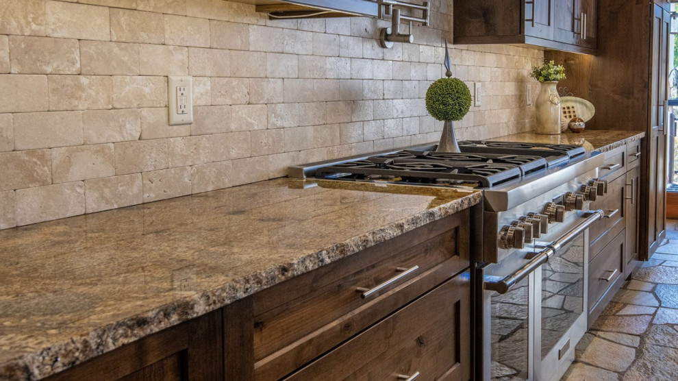 Eat-in kitchen - large single-wall cement tile floor and gray floor eat-in kitchen idea in Denver with an undermount sink, shaker cabinets, dark wood cabinets, granite countertops, beige backsplash, stone tile backsplash, stainless steel appliances, an island and beige countertops