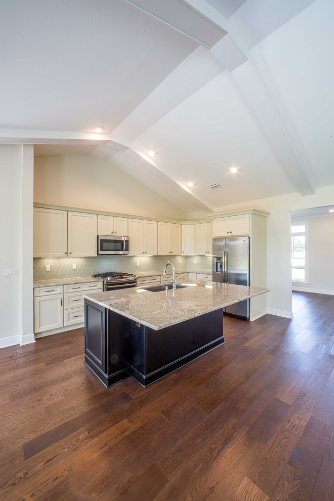 Inspiration for a mid-sized timeless galley medium tone wood floor and brown floor eat-in kitchen remodel with an undermount sink, recessed-panel cabinets, white cabinets, granite countertops, green backsplash, glass tile backsplash, stainless steel appliances, an island and multicolored countertops