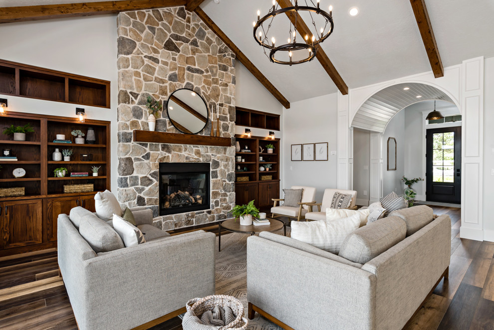 This is an example of a country formal living room in Other with dark hardwood floors, a wood stove, a stone fireplace surround, no tv and grey walls.